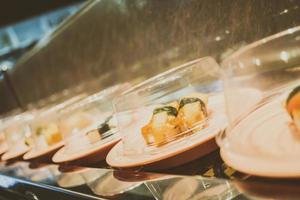 Sushi tray on conveyor belt photo