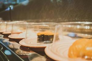 Sushi tray on conveyor belt photo