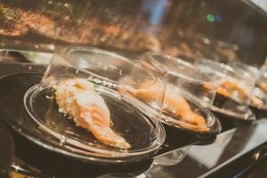 Sushi tray on conveyor belt photo