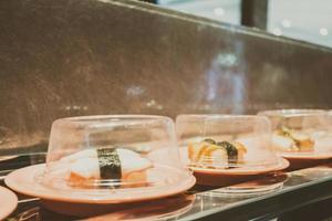 Sushi tray on conveyor belt photo