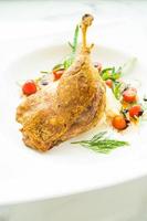 Fried duck leg with potato salad photo