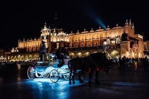 Krakow, Poland 2017- The old square of the night in Krakow with horse-drawn carriages photo