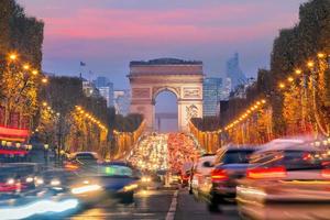 Famosos Campos Elíseos y el Arco del Triunfo en el crepúsculo en París foto