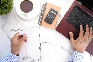 Person using white credit card to shop online photo