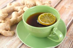 Ginger tea with lemon in green mug photo