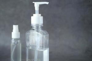 Two bottles of hand sanitizers on neutral grey background photo