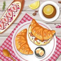 Top view of croissant with a tea cup on the table vector