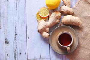 Top view of ginger tea on wooden background photo