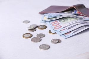 Close up of cash in wallet on table photo