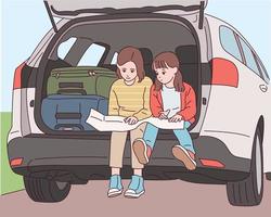 Cute little sisters are sitting in the trunk behind the car and looking at the map. vector