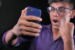 hombre de camisa morada con teléfono inteligente foto