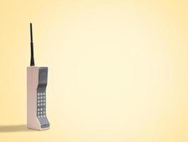 Vintage 80's mobile phone on yellow retro background with space for copy and text photo