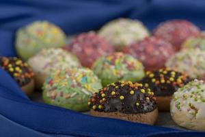 Colorful sweet small doughnuts with sprinkles photo