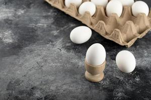 A wooden eggcup with a boiled chicken egg photo