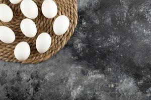 White raw chicken eggs on a sackcloth photo