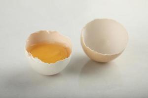 Broken organic egg on a white background photo