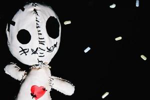 Voodoo doll on a black background photo