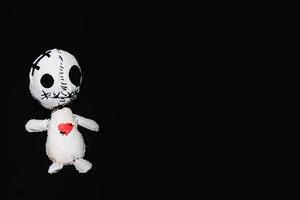 Voodoo doll on a black background photo