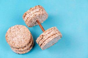 Useful loaves of sprouted cereals in a round shape in the form of a dumbbell on a blue background photo