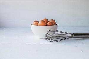 Eggs in a bowl with a whisk photo