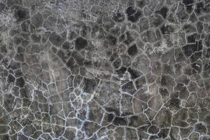 Cracked dark gray concrete photo