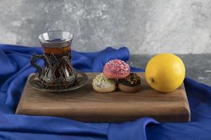 Colorful sweet doughnuts with a cup of tea photo