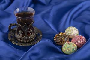 Colorful sweet doughnuts with a cup of tea photo