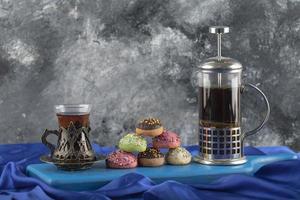 Colorful sweet doughnuts with a cup of tea photo