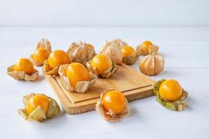 Cape gooseberries on a wooden board photo