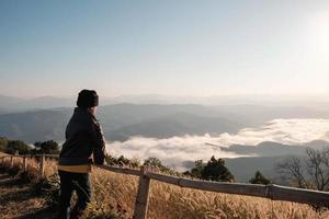 Woman looking out towards scenic view photo