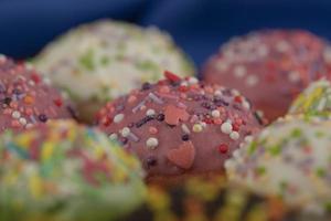 Colorful sweet chocolate small doughnuts with sprinkles photo