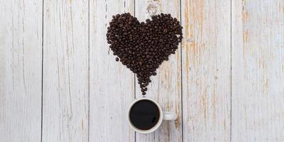 Coffee beans arranged in a heart shape, love drinking coffee concept photo