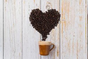 Coffee beans arranged in a heart shape, love drinking coffee concept photo