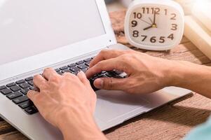 A person's hands using a notebook computer photo