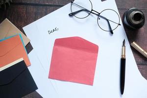 Envelope and glasses on a desk top photo