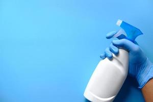 Hand holding a disinfecting spray bottle photo