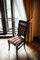 Old vintage chair on oak flooring photo