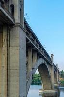 Road and rail split-level bridge over the river photo