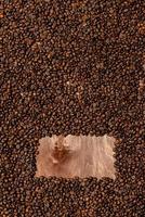 Background texture of dark wooden board and frame of coffee beans photo