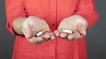 Broken cigarettes in hands photo