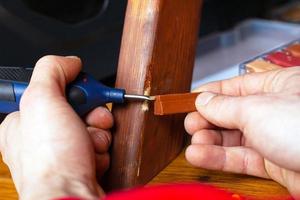 Person repairing wood photo