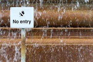 Sign prohibiting entry in the pool at the city fountain photo