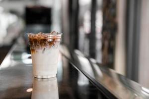 Iced coffee with milk on the bar photo