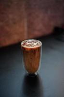 Iced coffee with milk on the table photo