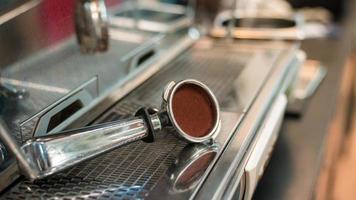 Coffee tamper resting on a coffee machine photo