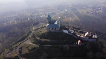 Drone orbitando el antiguo castillo con torre sobre una roca en un soleado día de primavera en 4 k video