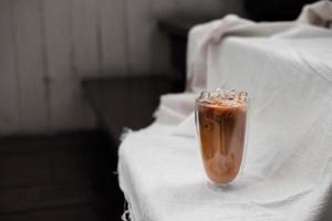 Iced coffee with milk on white fabric