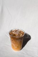Close-up of iced coffee on white fabric background photo