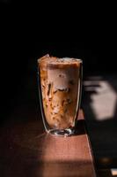 Close-up glass of iced coffee with milk on the table photo