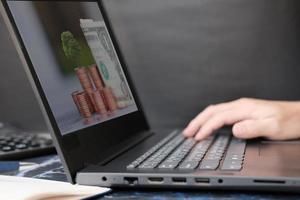 Businessman's hand working on laptop computer, technology concept photo